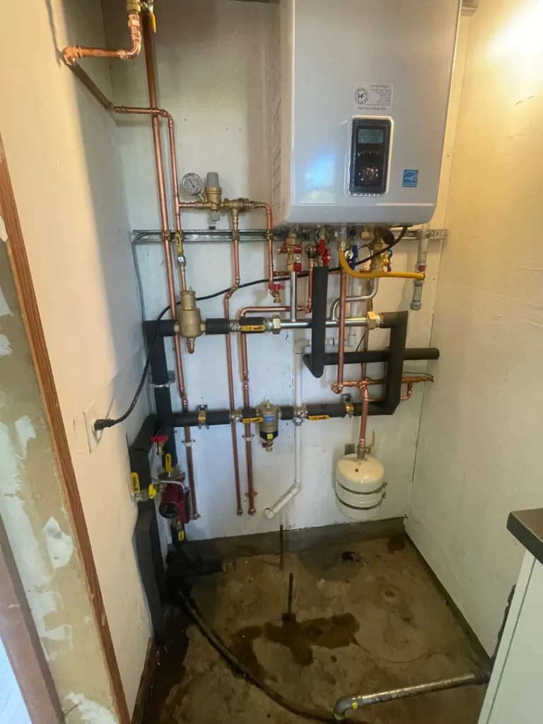 Wall-mounted Navien boiler with copper piping and expansion tank installed by Hydroflow in San Francisco