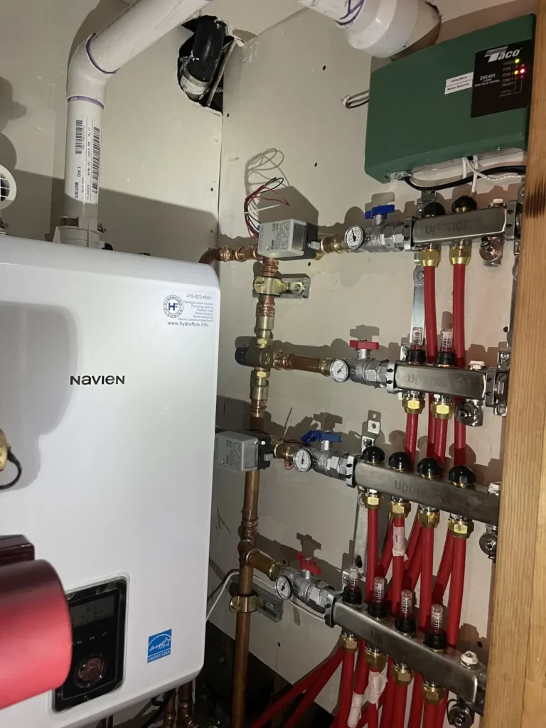 Navien boiler with Uponor radiant manifolds and Taco zone controller installed by Hydroflow for Eichler radiant heating