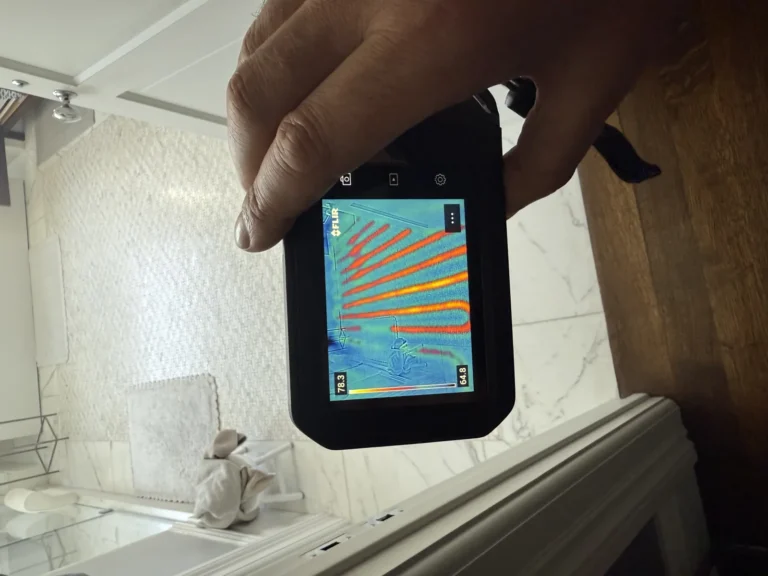FLIR thermal camera showing radiant floor heating pattern under bathroom tile during Hydroflow diagnostic inspection