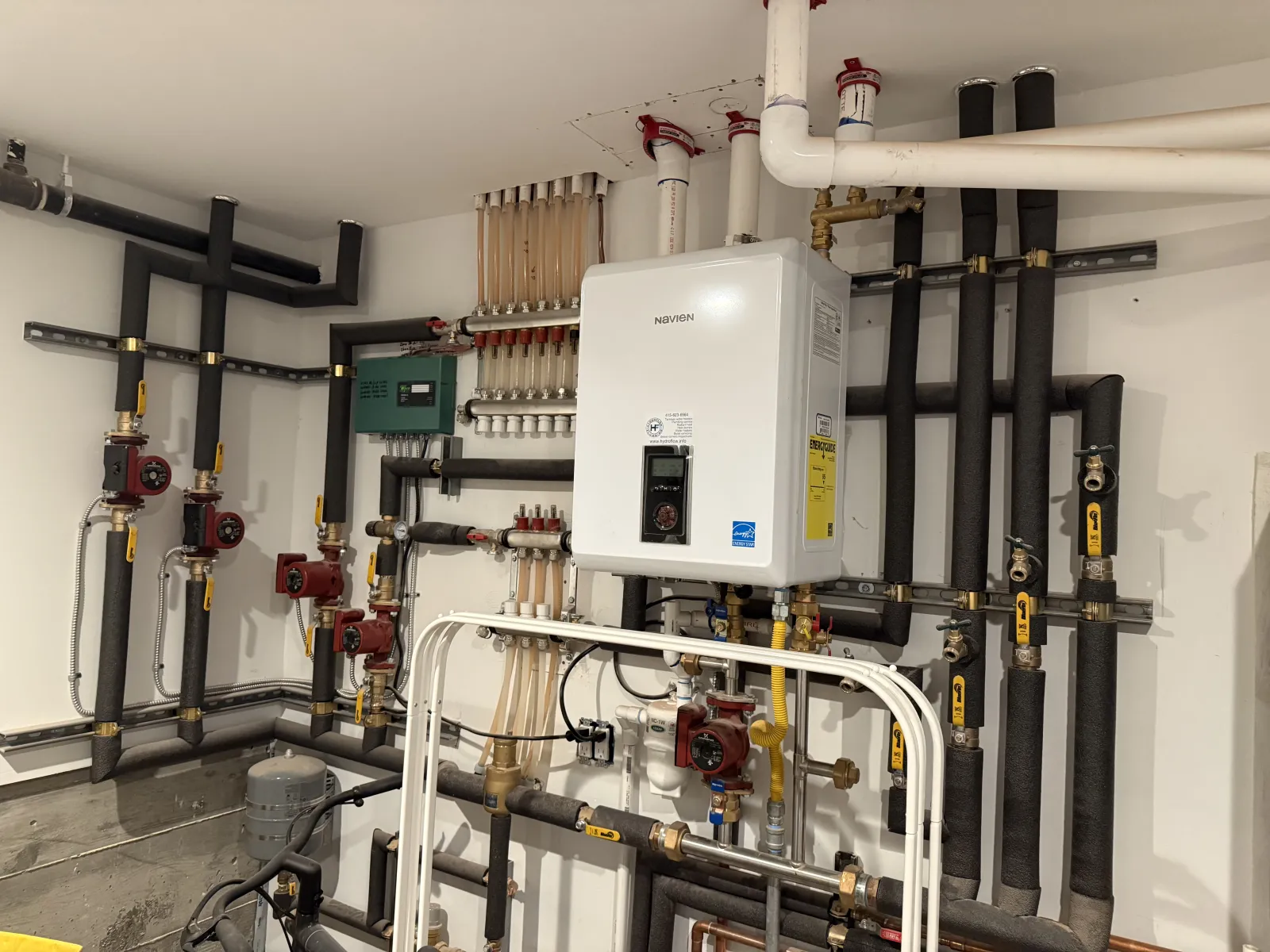 Navien NCB combi-boiler installed by Hydroflow with radiant manifolds and circulation pumps in a San Francisco home