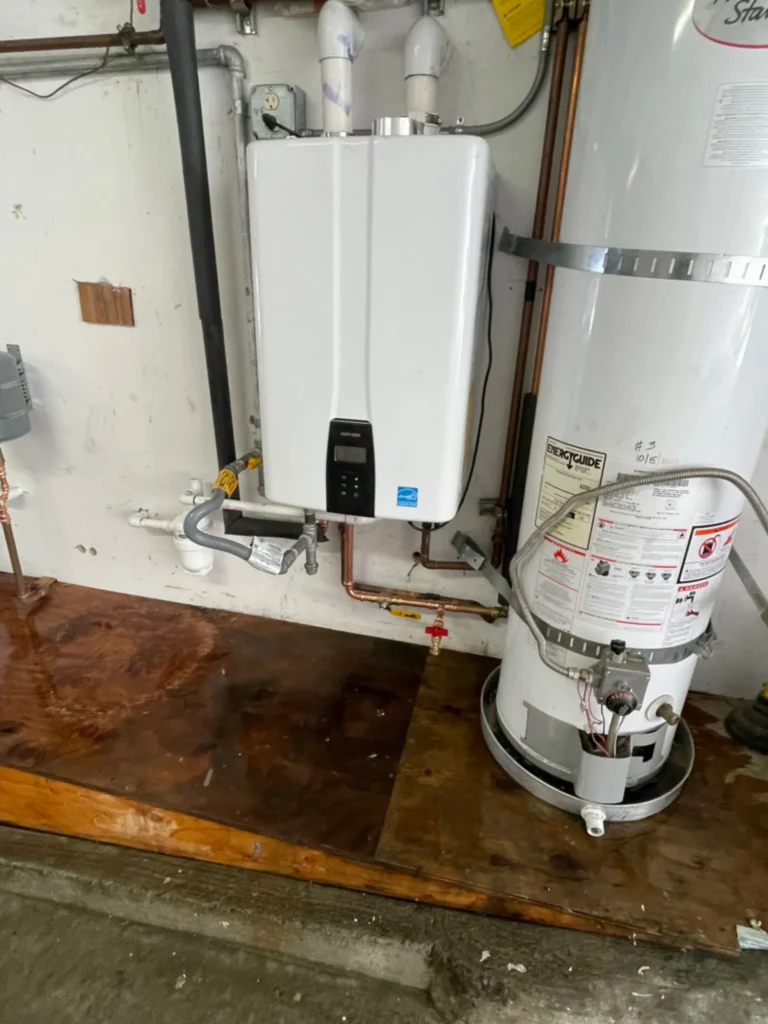 Navien tankless water heater installed next to an old tank water heater in a San Francisco garage by Hydroflow