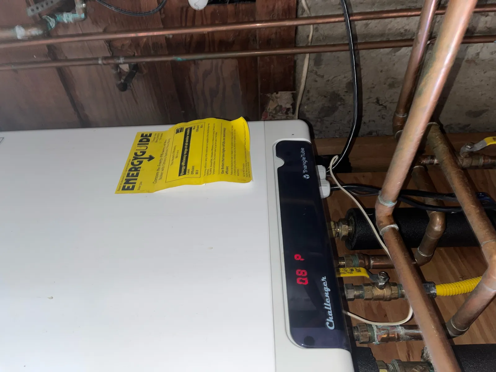 Triangle Tube Challenger boiler displaying error code with EnergyGuide label during troubleshooting by Hydroflow